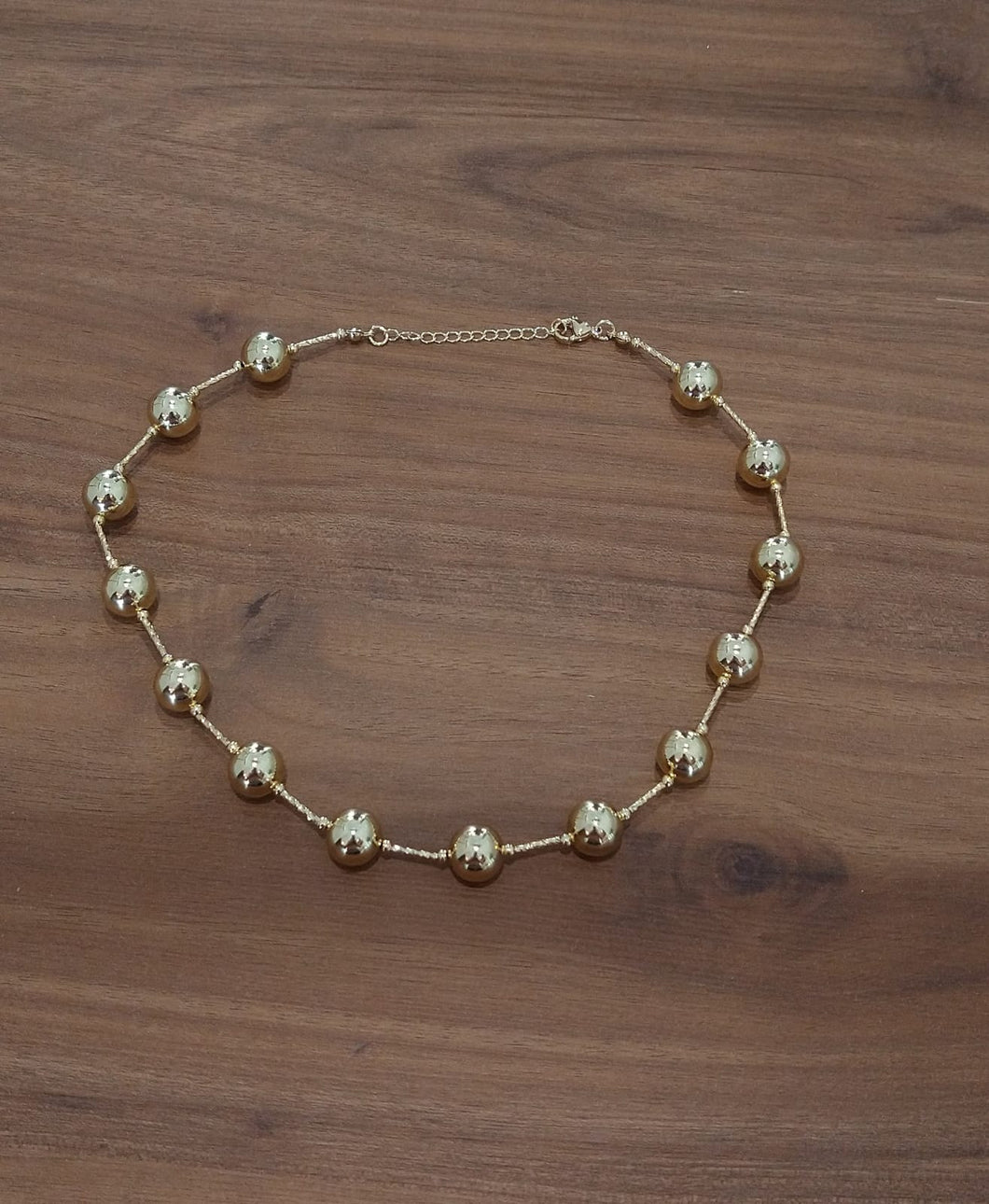 Collar corto de bola y barra dorado
